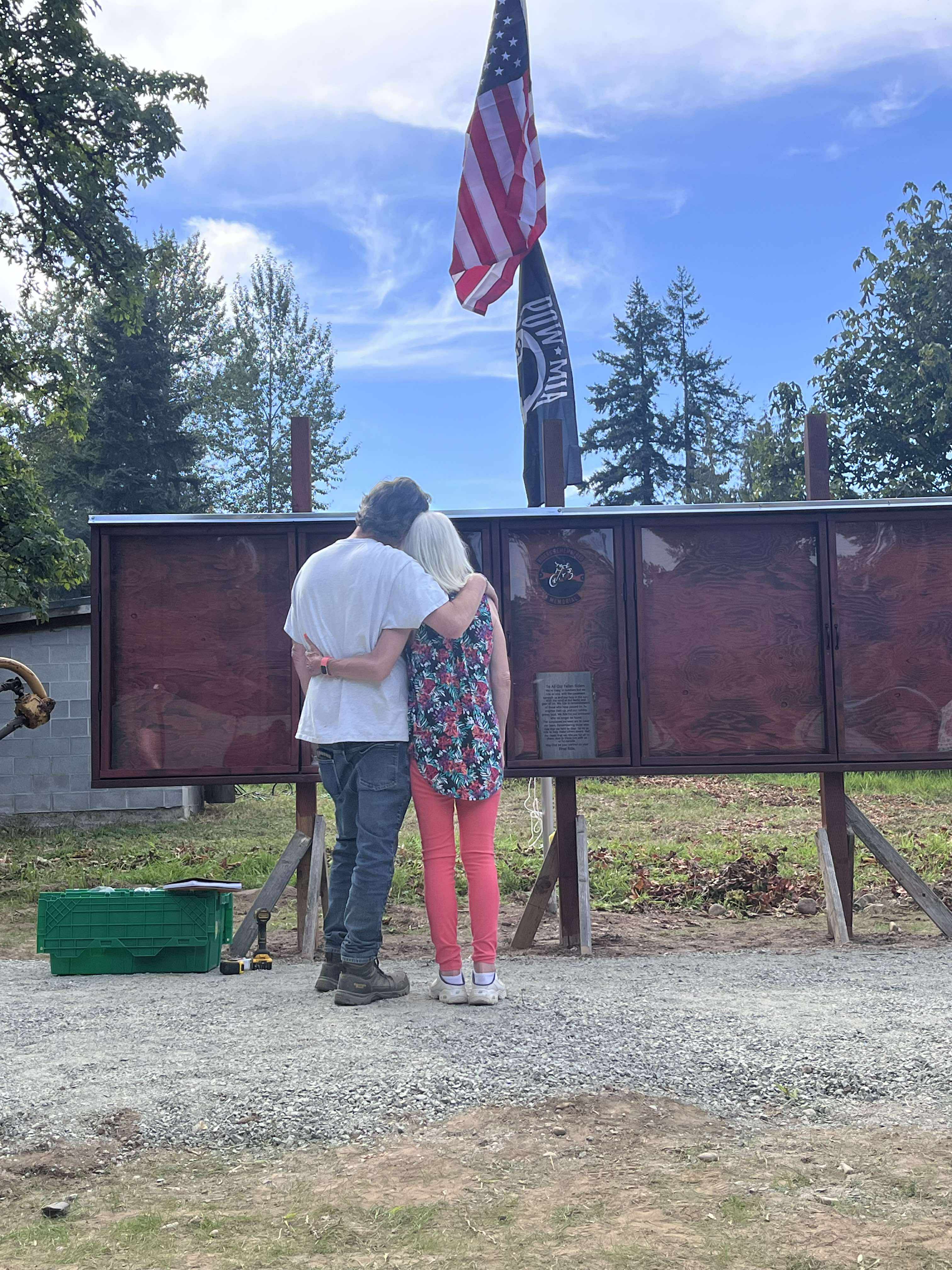 Two people reflecting together at the memorial wall